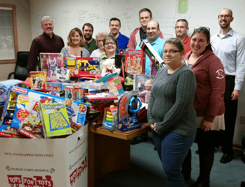 The IQ Inc. team and their 2015 donation to Toys for Tots