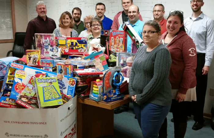 The IQ Inc. team and their 2015 donation to Toys for Tots
